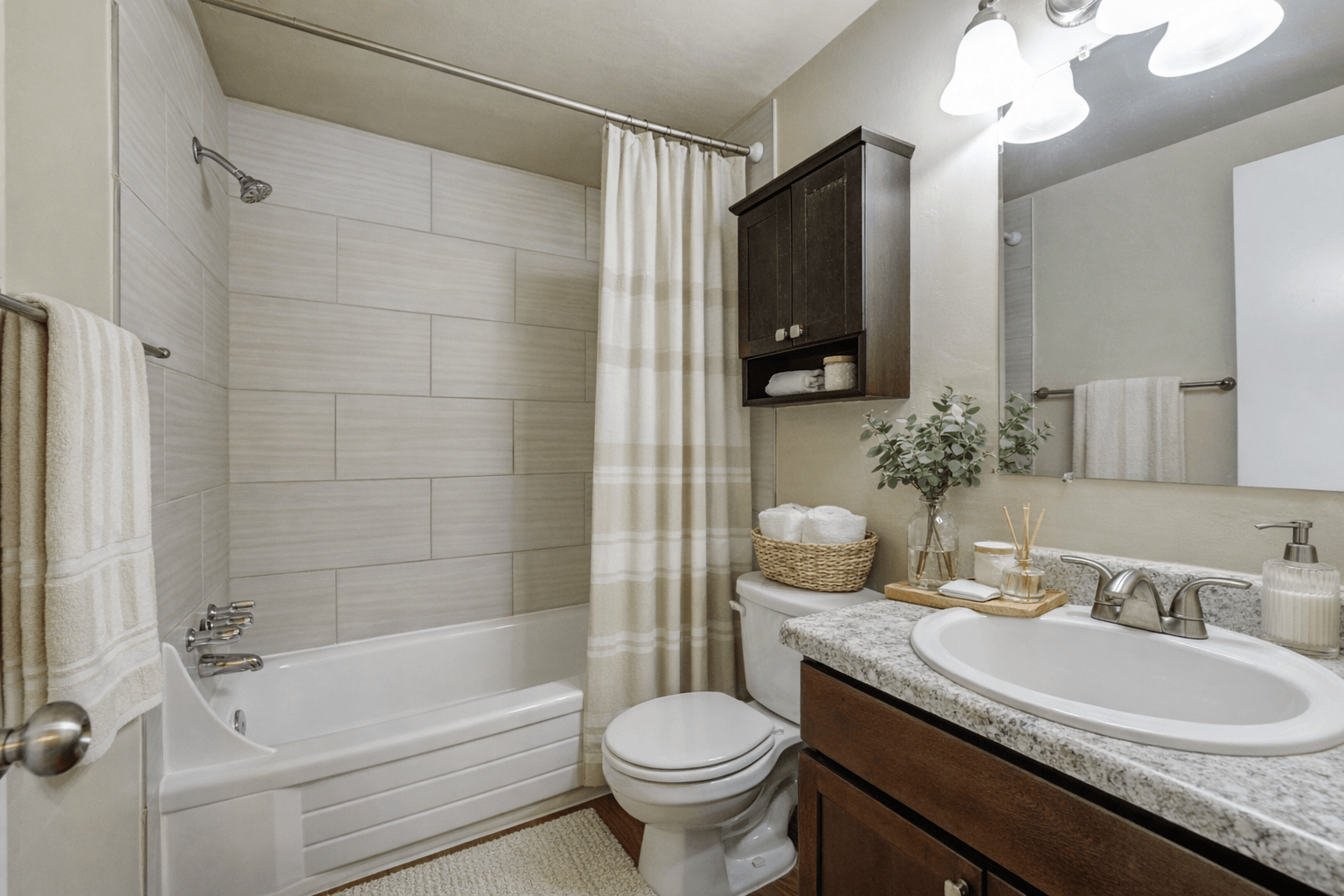 A white bathroom with a toilet, sink, and bathtub.